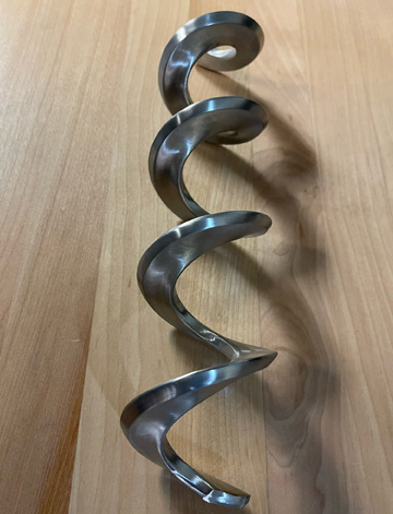 Flexible screw conveyor knife edge spiral from AFC transfers sticky bulk materials